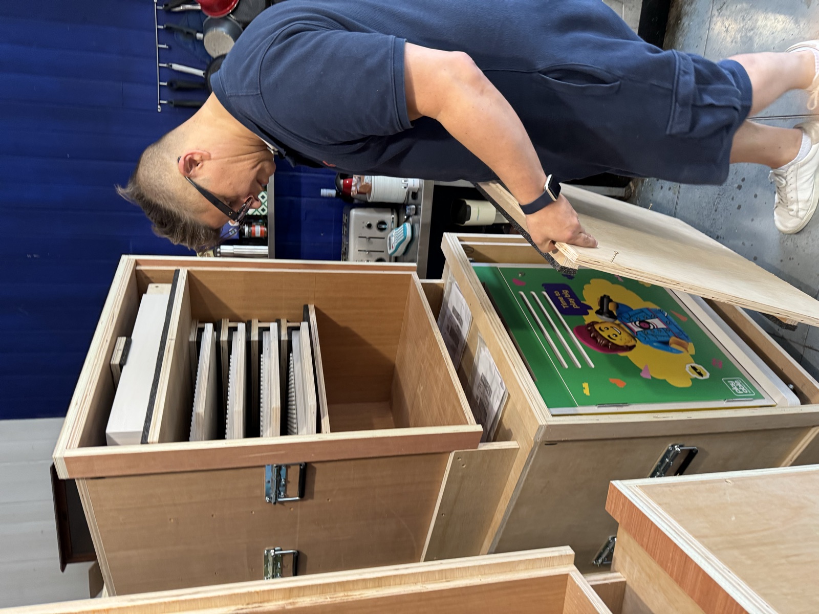 Brick trays and parts being packed into a fitted shipping crate for transit.
