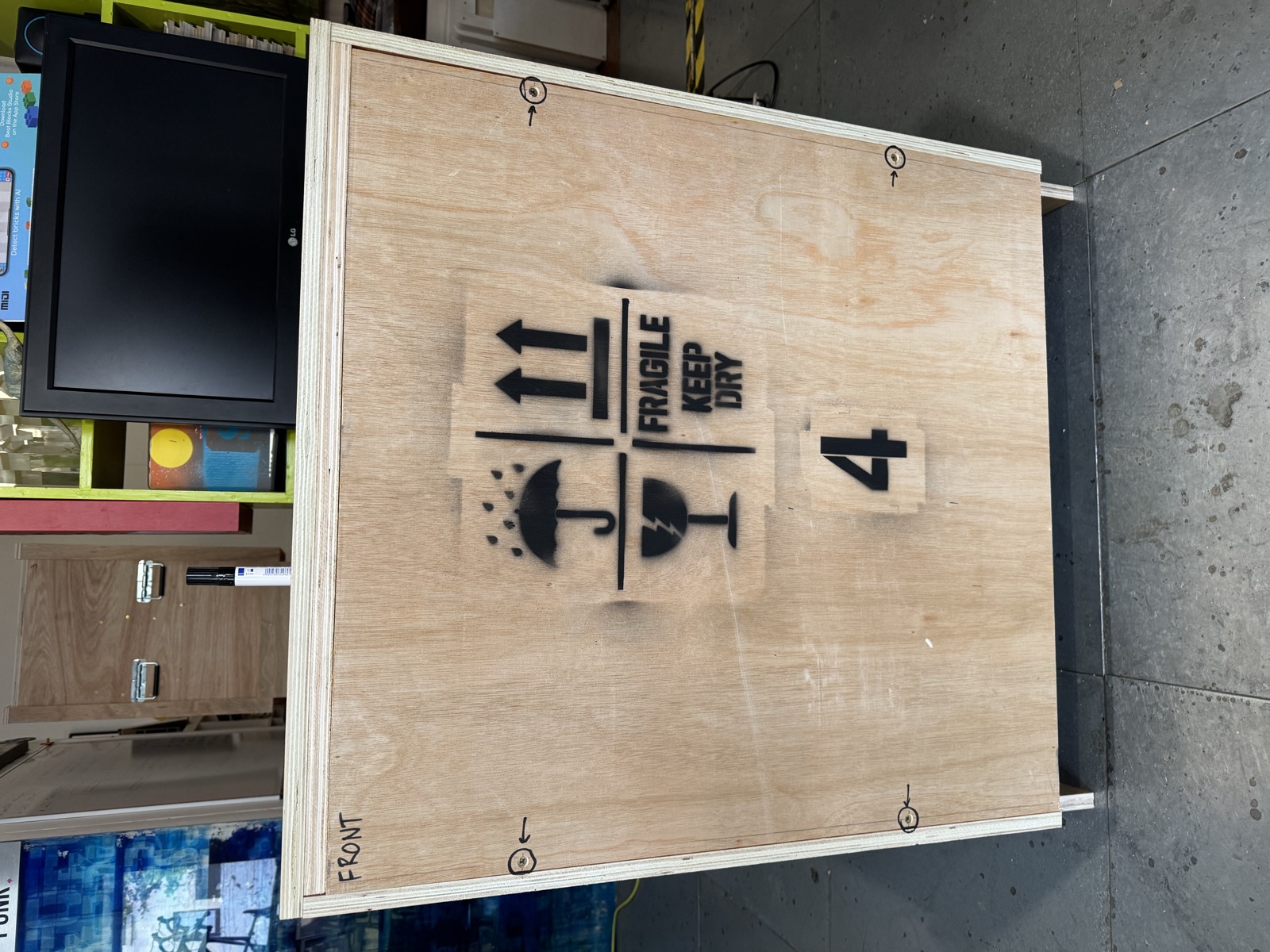 A sealed BeatBricks shipping crate, stencilled with handling marks and its station number, ready for freight.