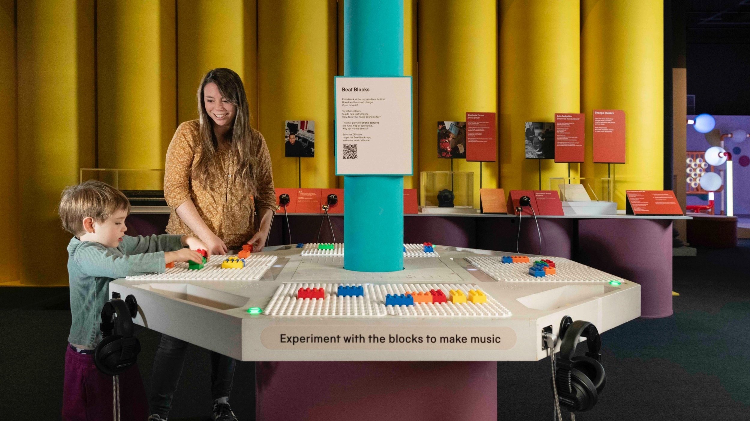 A woman and child play the BeatBlocks Live installation together.