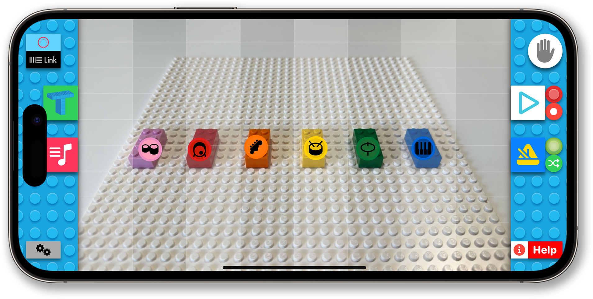 The BeatBlocks app on a phone: coloured bricks on a baseplate, each tagged with an instrument icon.