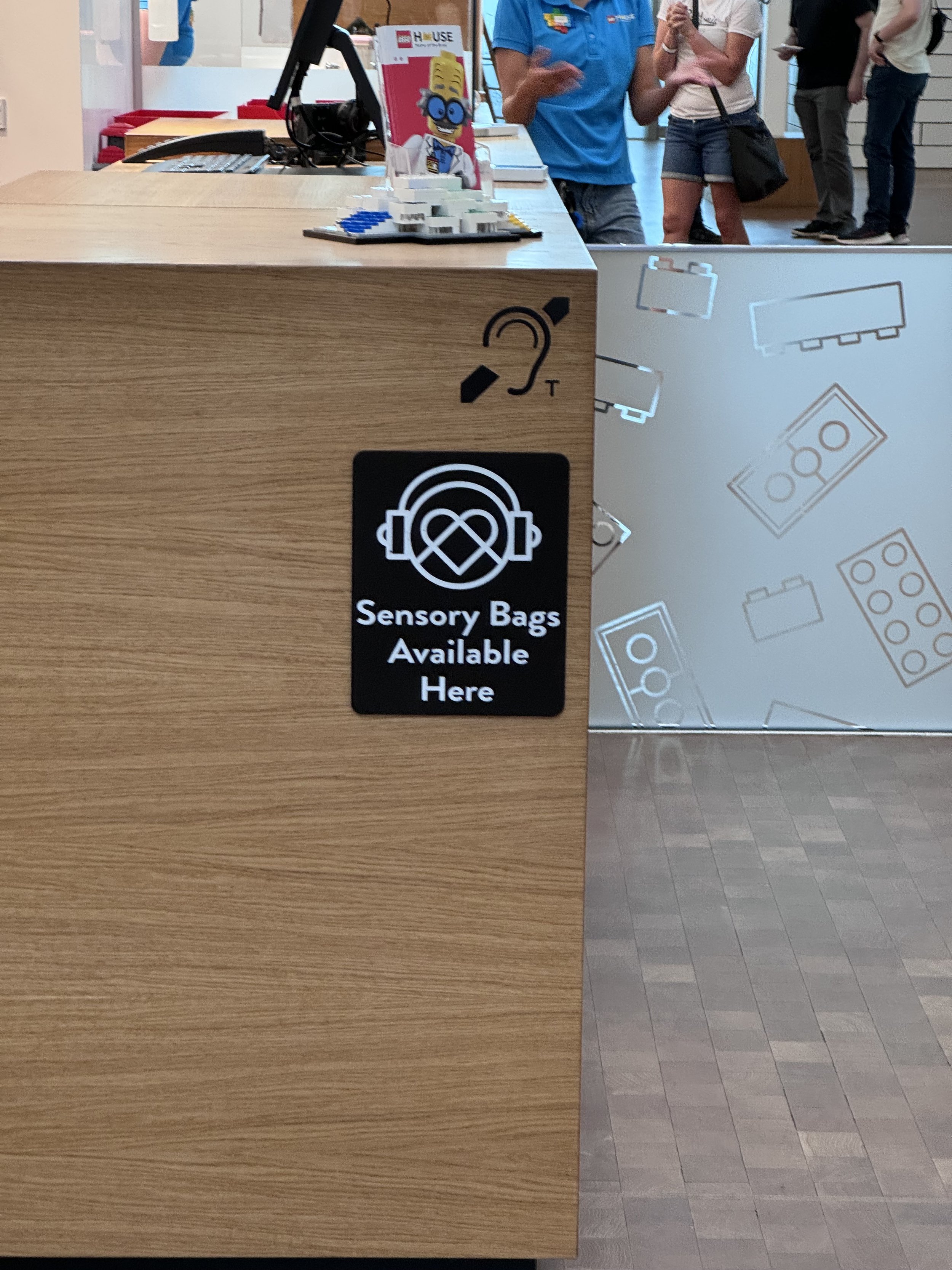 A "Sensory Bags Available" sign inside the LEGO House.