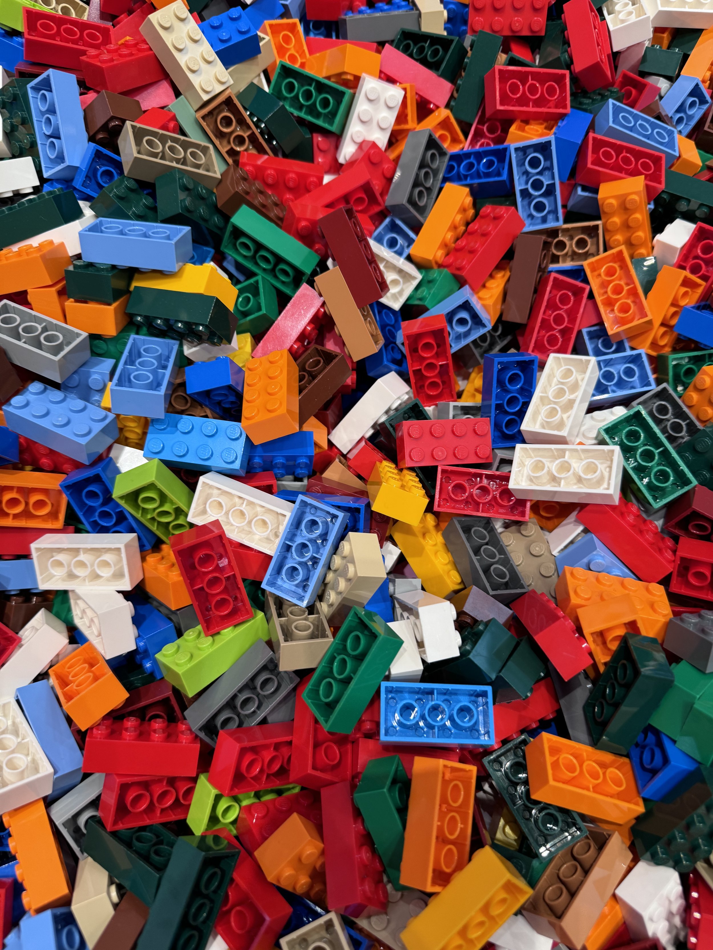 A large pile of multicoloured LEGO 2x4 bricks.