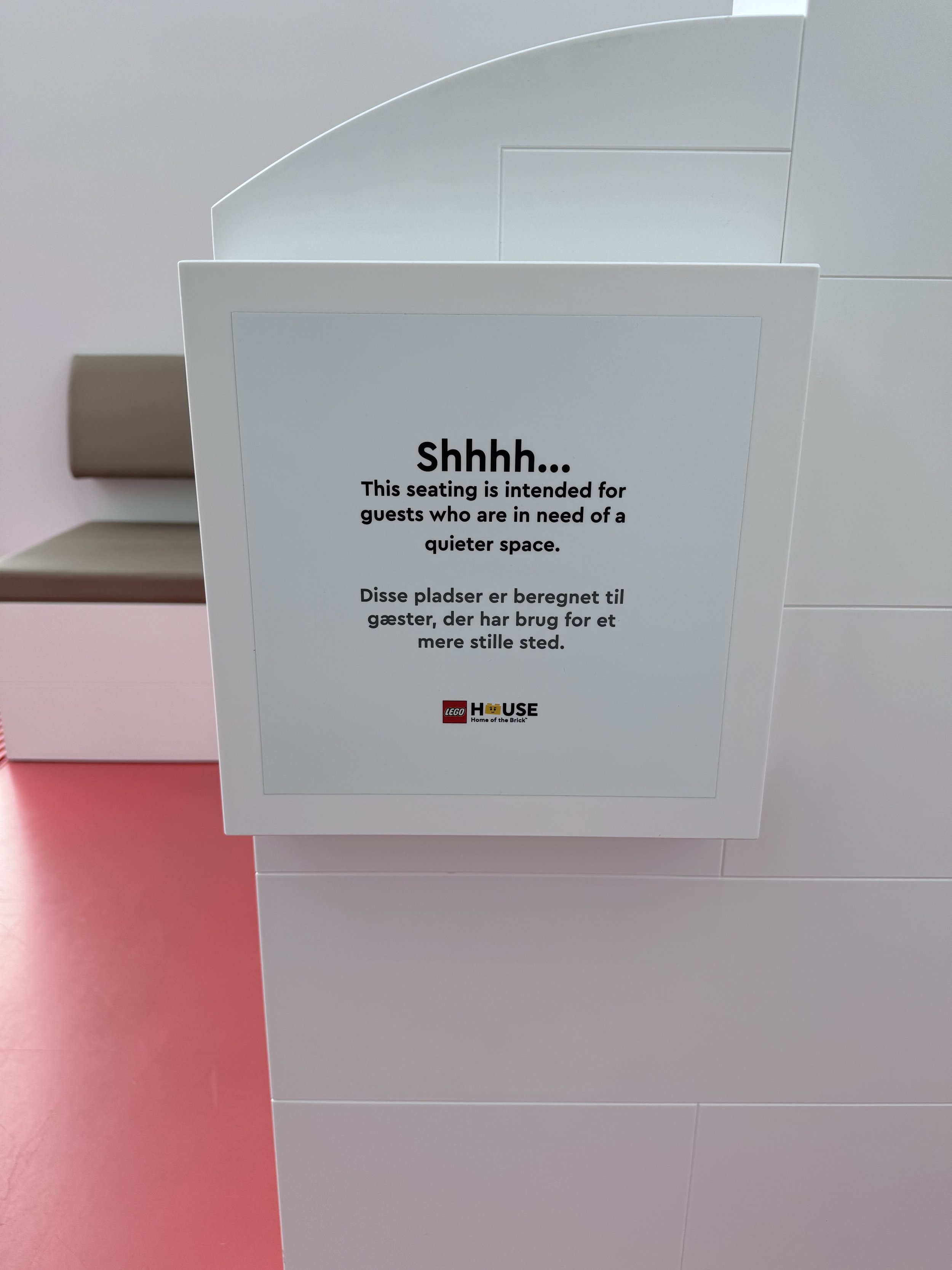 An accessibility sign inside the LEGO House marking a seating area for people who need a calm, quiet space.