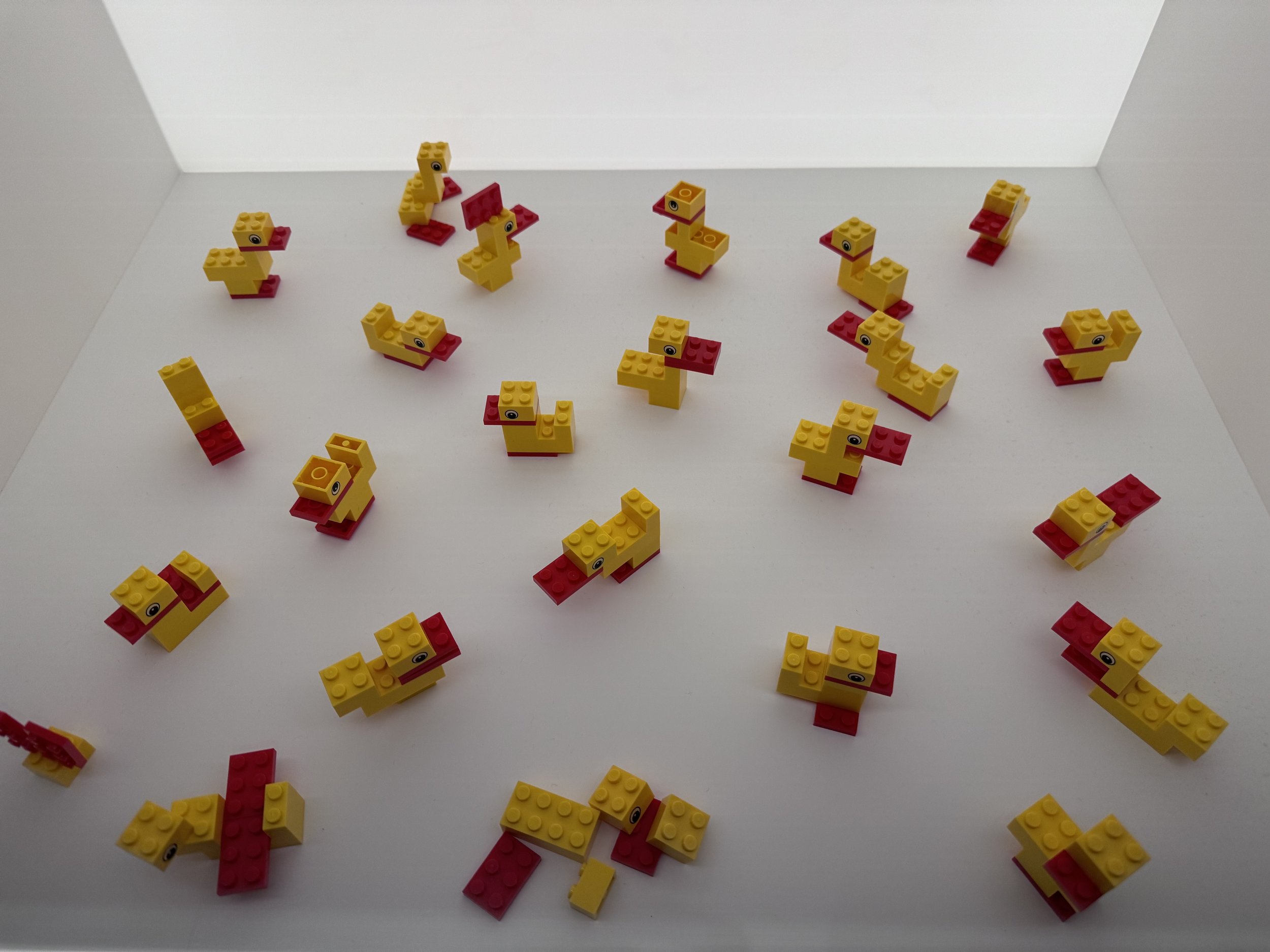 A LEGO House exhibit showing a variety of classic yellow and red LEGO ducks.