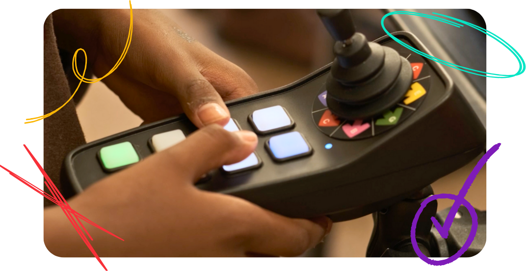 Hands holding a Digit CMPSR accessibility controller.
