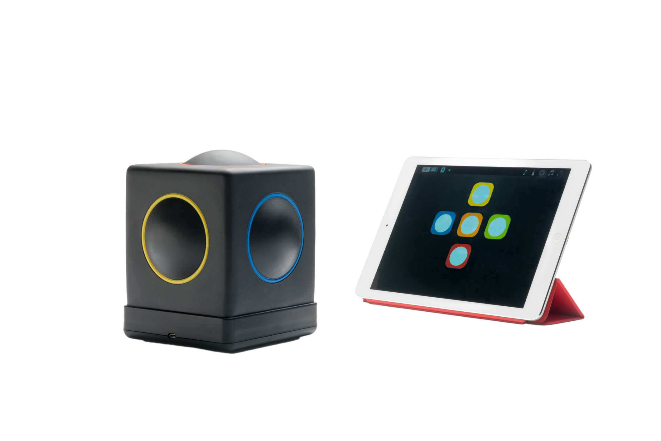 A Skoog cube instrument beside an iPad showing the colourful Skoog app.